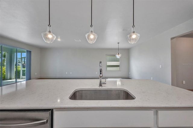 16848 Canopy Garden Dr, Port Charlotte, FL 33953 - kitchen featuring open floor plan, light stone countertops, white cabinets, stainless steel dishwasher, and pendant lighting