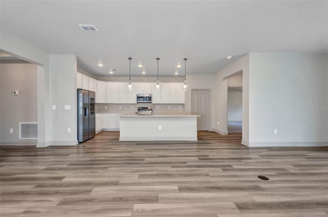 16848 Canopy Garden Dr, Port Charlotte, FL 33953 - kitchen featuring stainless steel appliances, open floor plan, light countertops, recessed lighting, and light wood-style flooring