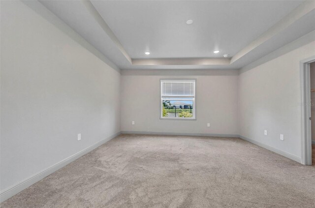 16848 Canopy Garden Dr, Port Charlotte, FL 33953 - carpeted empty room featuring a tray ceiling and recessed lighting