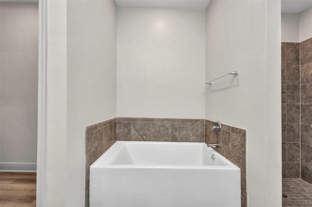 16848 Canopy Garden Dr, Port Charlotte, FL 33953 - bathroom with a garden tub, wood finished floors, and tiled shower