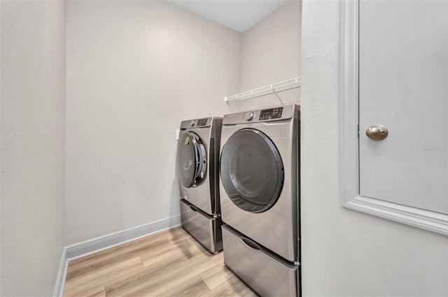 16848 Canopy Garden Dr, Port Charlotte, FL 33953 - laundry area featuring washer and dryer and light wood-type flooring