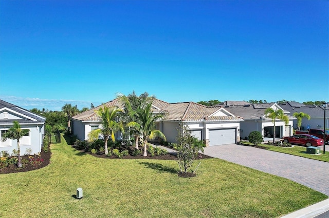 14436 Ponce De Leon Trl, Port Charlotte, FL 33981 - view of front of house with an attached garage, a front yard, driveway, a residential view, and stucco siding