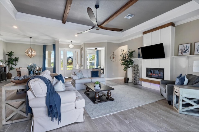 14436 Ponce De Leon Trl, Port Charlotte, FL 33981 - living area featuring ceiling fan, a glass covered fireplace, ornamental molding, wood finished floors, and beam ceiling