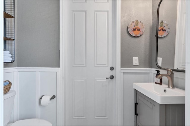 14436 Ponce De Leon Trl, Port Charlotte, FL 33981 - bathroom featuring a decorative wall, vanity, and a wainscoted wall