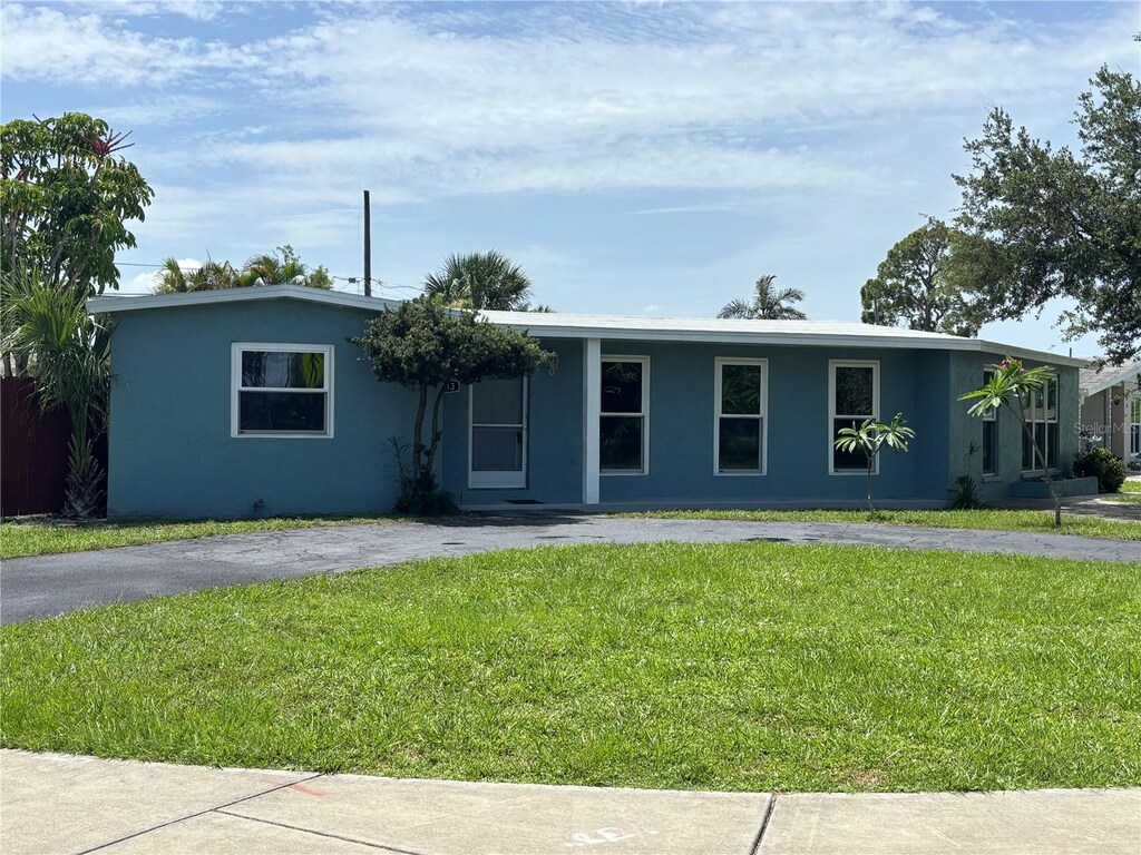 2513 Ambrose Ln, Port Charlotte, FL 33952 - ranch-style home with a front lawn and stucco siding