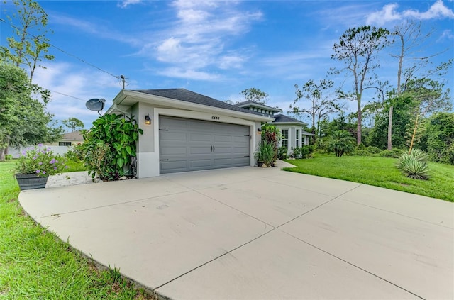 6444 Alhambra Ave, North Port, FL 34291 - view of front of home featuring concrete driveway, a front lawn, stucco siding, and a garage