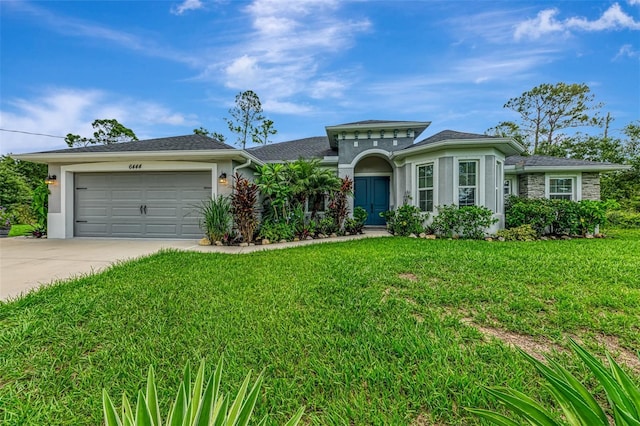 6444 Alhambra Ave, North Port, FL 34291 - mediterranean / spanish-style home with concrete driveway, stucco siding, and a front lawn
