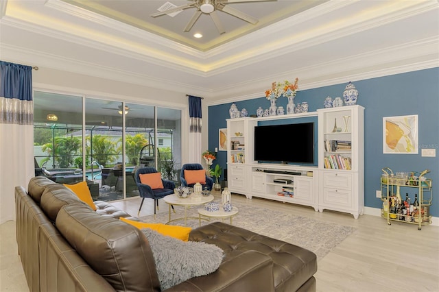 6444 Alhambra Ave, North Port, FL 34291 - living area with a ceiling fan, a tray ceiling, ornamental molding, wood finished floors, and a sunroom