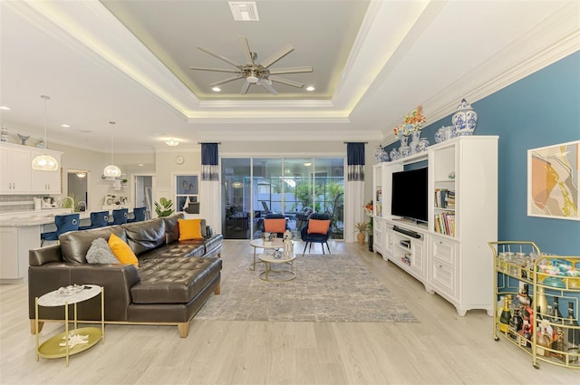 6444 Alhambra Ave, North Port, FL 34291 - living area with a ceiling fan, light wood finished floors, a raised ceiling, ornamental molding, and recessed lighting