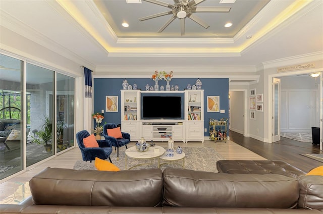 6444 Alhambra Ave, North Port, FL 34291 - living area with a tray ceiling, a ceiling fan, wood finished floors, and ornamental molding