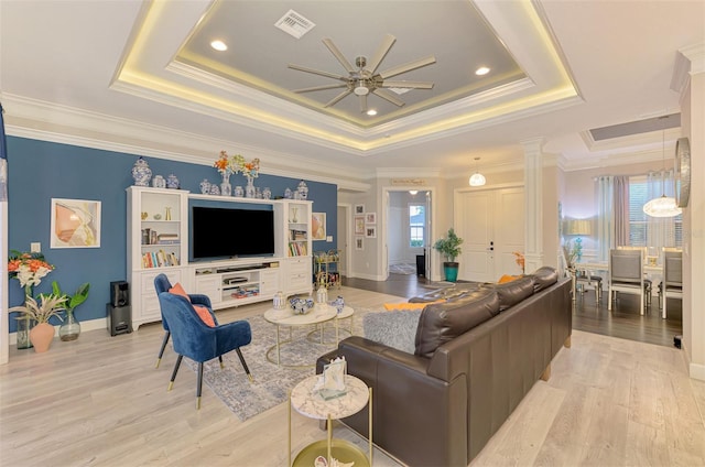 6444 Alhambra Ave, North Port, FL 34291 - living room with a tray ceiling, ceiling fan, ornamental molding, and light wood-type flooring