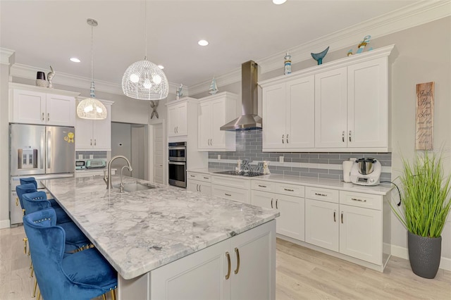 6444 Alhambra Ave, North Port, FL 34291 - kitchen featuring stainless steel appliances, wall chimney range hood, white cabinetry, crown molding, and a breakfast bar area