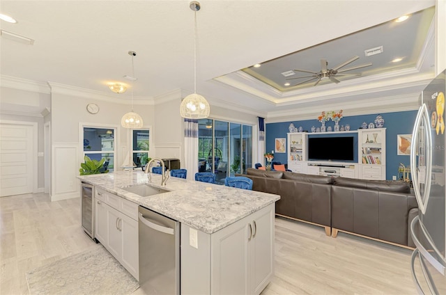 6444 Alhambra Ave, North Port, FL 34291 - kitchen with appliances with stainless steel finishes, ceiling fan, light wood-style floors, white cabinets, and an island with sink