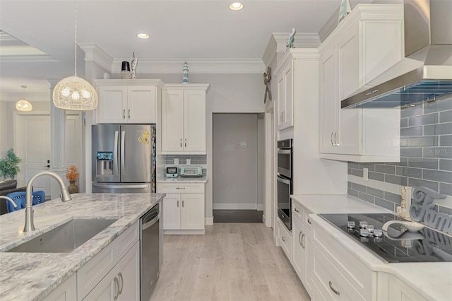 6444 Alhambra Ave, North Port, FL 34291 - kitchen featuring wall chimney exhaust hood, appliances with stainless steel finishes, white cabinets, tasteful backsplash, and decorative light fixtures