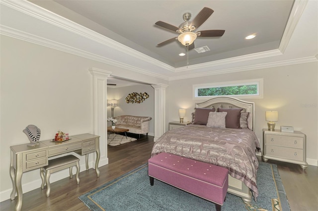 6444 Alhambra Ave, North Port, FL 34291 - bedroom featuring decorative columns, a tray ceiling, wood finished floors, crown molding, and ceiling fan