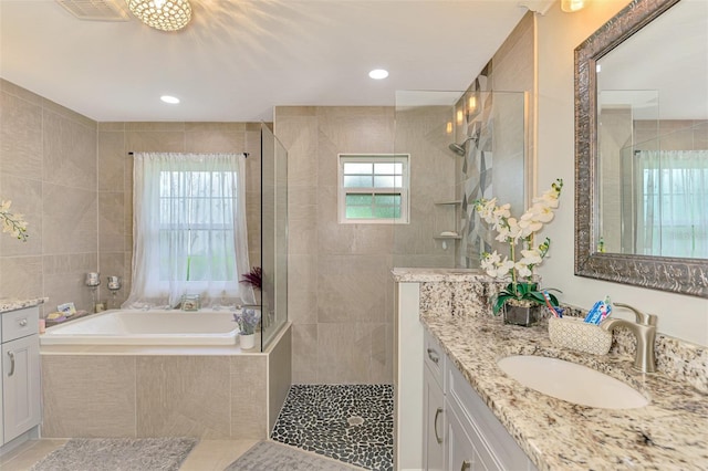 6444 Alhambra Ave, North Port, FL 34291 - full bathroom with vanity, walk in shower, a garden tub, and tile patterned floors