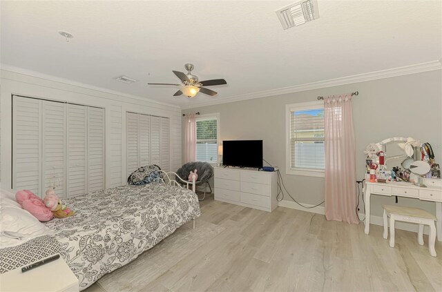 6444 Alhambra Ave, North Port, FL 34291 - bedroom with crown molding, light wood finished floors, two closets, and ceiling fan