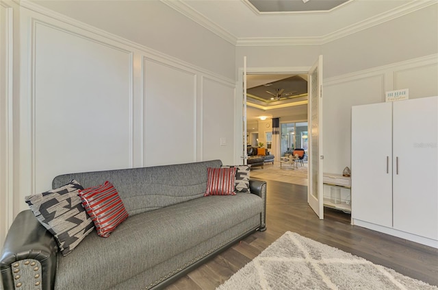 6444 Alhambra Ave, North Port, FL 34291 - living area featuring crown molding, dark wood-style floors, a tray ceiling, and a decorative wall