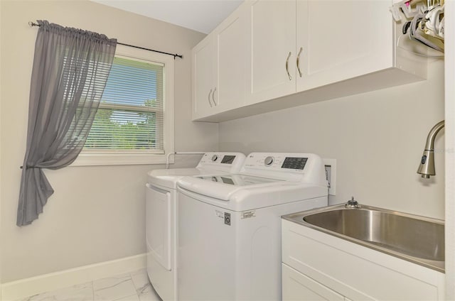 6444 Alhambra Ave, North Port, FL 34291 - laundry area featuring washing machine and dryer, cabinet space, and light marble finish floors