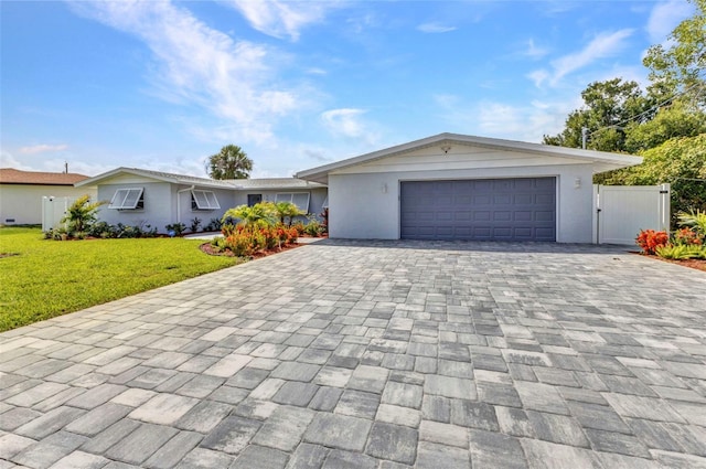4244 Harbor Blvd, Port Charlotte, FL 33952 - ranch-style house with decorative driveway, a front lawn, stucco siding, and an attached garage