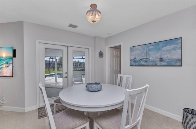 4244 Harbor Blvd, Port Charlotte, FL 33952 - dining area with french doors and light carpet
