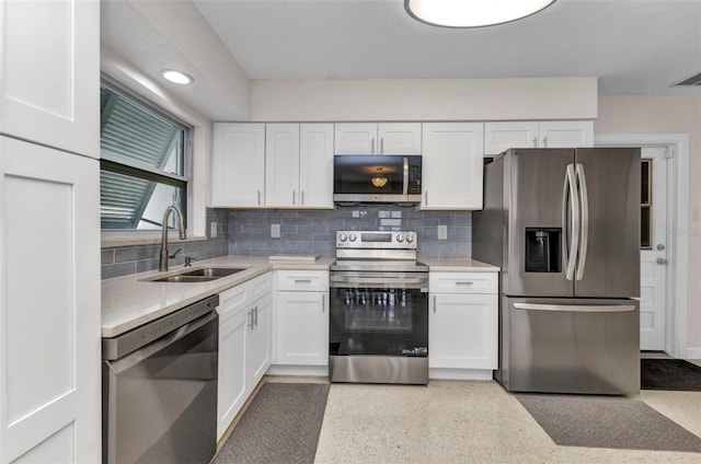 4244 Harbor Blvd, Port Charlotte, FL 33952 - kitchen featuring appliances with stainless steel finishes, white cabinetry, light countertops, decorative backsplash, and dark speckled floor