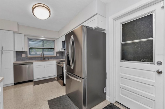 4244 Harbor Blvd, Port Charlotte, FL 33952 - kitchen with appliances with stainless steel finishes, white cabinetry, tasteful backsplash, light countertops, and dark aggregate flooring