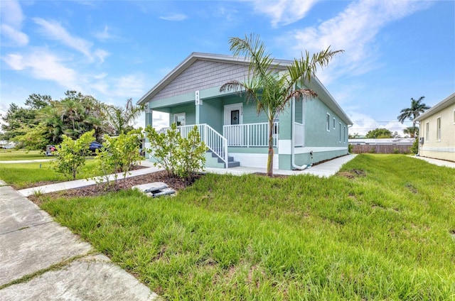419 Carmalita St, Punta Gorda, FL 33950 - view of front of property with covered porch and a front yard