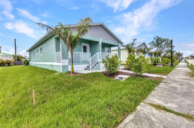 419 Carmalita St, Punta Gorda, FL 33950 - view of front of house featuring covered porch and a front yard