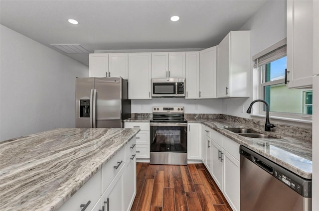 419 Carmalita St, Punta Gorda, FL 33950 - kitchen featuring appliances with stainless steel finishes, light stone counters, white cabinetry, and recessed lighting