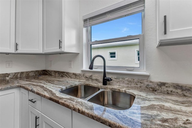 419 Carmalita St, Punta Gorda, FL 33950 - kitchen featuring white cabinets and light stone counters