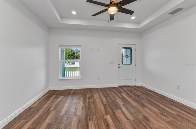 419 Carmalita St, Punta Gorda, FL 33950 - spare room featuring a tray ceiling, dark wood-type flooring, a ceiling fan, and recessed lighting