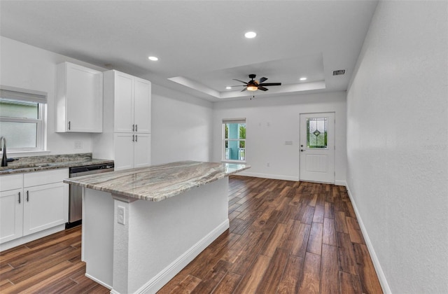 419 Carmalita St, Punta Gorda, FL 33950 - kitchen featuring stainless steel dishwasher, light stone countertops, dark wood-type flooring, white cabinetry, and recessed lighting