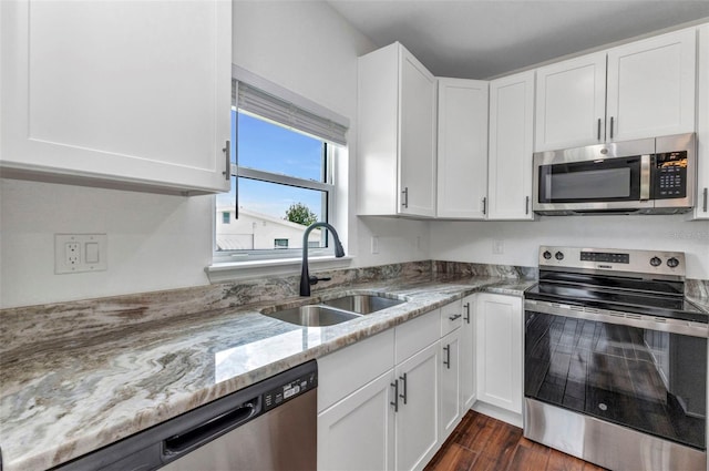 419 Carmalita St, Punta Gorda, FL 33950 - kitchen featuring appliances with stainless steel finishes, white cabinets, and light stone counters