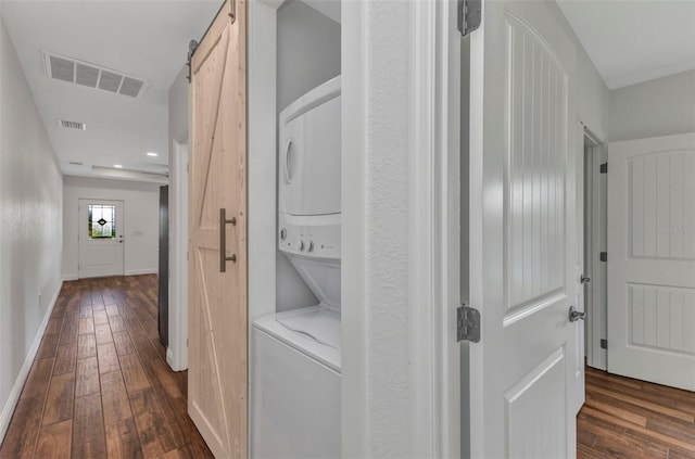 419 Carmalita St, Punta Gorda, FL 33950 - hallway featuring stacked washing machine and dryer, dark wood finished floors, a barn door, and recessed lighting