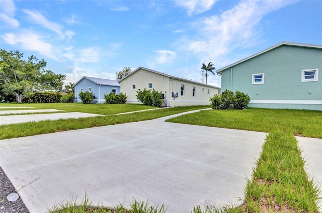 419 Carmalita St, Punta Gorda, FL 33950 - rear view of house featuring a lawn and stucco siding
