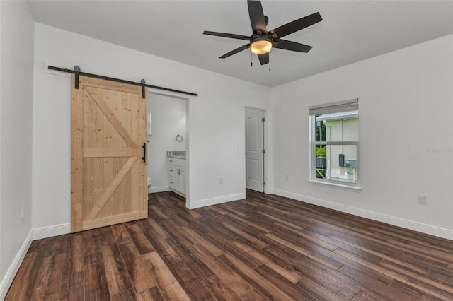 419 Carmalita St, Punta Gorda, FL 33950 - unfurnished bedroom featuring a barn door, wood finished floors, ensuite bath, and ceiling fan