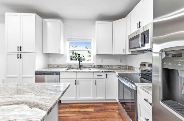 419 Carmalita St, Punta Gorda, FL 33950 - kitchen with appliances with stainless steel finishes, light stone countertops, and white cabinets