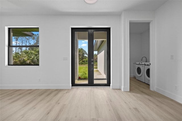17156 Eugene Ave, Port Charlotte, FL 33954 - unfurnished dining area with separate washer and dryer, plenty of natural light, and wood finished floors