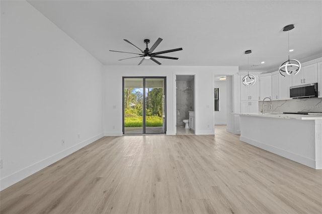 17156 Eugene Ave, Port Charlotte, FL 33954 - unfurnished living room featuring light wood-style floors, ceiling fan, and recessed lighting