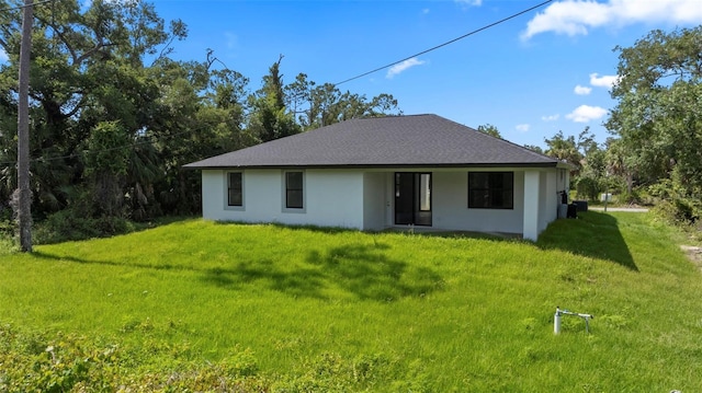 17156 Eugene Ave, Port Charlotte, FL 33954 - rear view of property featuring a lawn and stucco siding