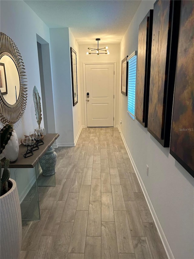 1992 Sunset Preserve Way, Port Charlotte, FL 33953 - hallway featuring a chandelier and light wood-style flooring