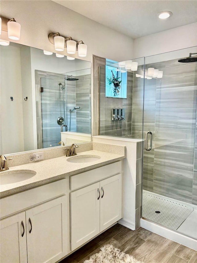 1992 Sunset Preserve Way, Port Charlotte, FL 33953 - bathroom featuring a shower stall, wood finished floors, double vanity, and recessed lighting