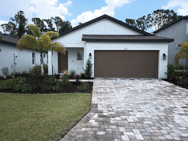 1992 Sunset Preserve Way, Port Charlotte, FL 33953 - view of front of property with decorative driveway, a front yard, an attached garage, and stucco siding