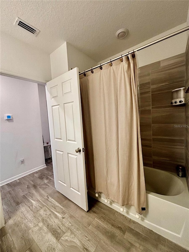 1992 Sunset Preserve Way, Port Charlotte, FL 33953 - bathroom with wood finished floors, shower / tub combo with curtain, and a textured ceiling