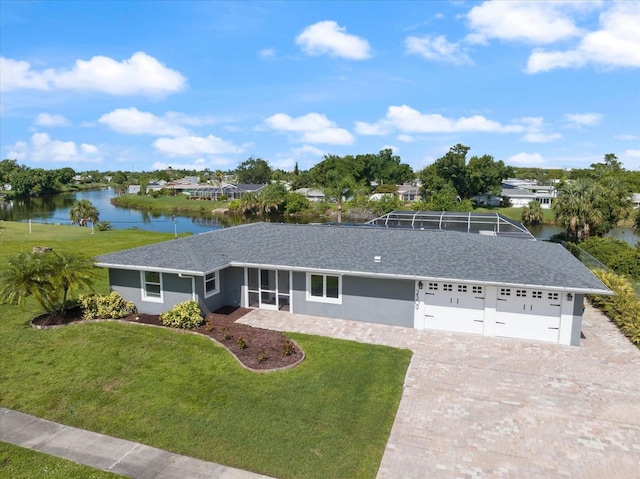 2309 Conway Blvd, Port Charlotte, FL 33952 - view of front of home with a water view, a front lawn, driveway, and a garage