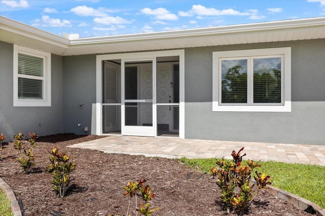 2309 Conway Blvd, Port Charlotte, FL 33952 - property entrance featuring stucco siding and a patio area