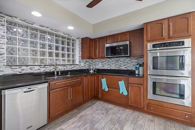 2309 Conway Blvd, Port Charlotte, FL 33952 - kitchen with appliances with stainless steel finishes, a ceiling fan, tasteful backsplash, light wood-style floors, and recessed lighting