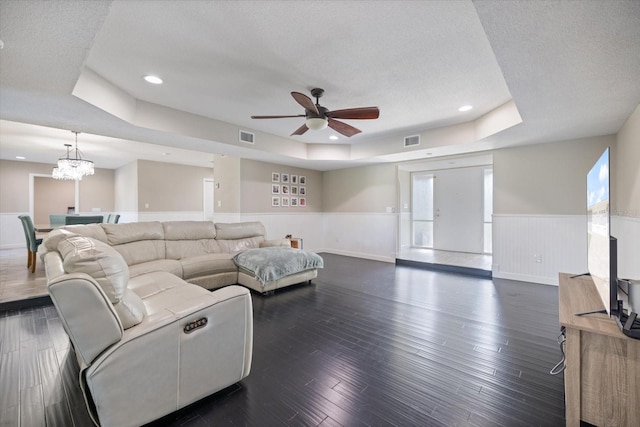 2309 Conway Blvd, Port Charlotte, FL 33952 - living room featuring a wainscoted wall, a textured ceiling, ceiling fan, a raised ceiling, and dark wood-style flooring