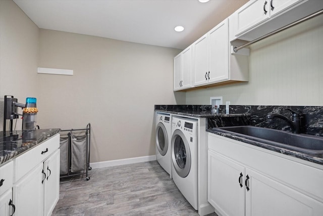 2309 Conway Blvd, Port Charlotte, FL 33952 - washroom featuring washing machine and dryer, cabinet space, light wood-style flooring, and recessed lighting